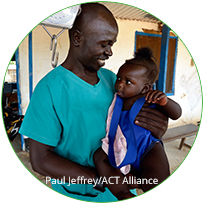 male health care worker holding a child